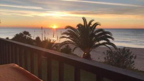 a sunset from the balcony of a resort at Paraiso frente al mar Apto duplex in Comarruga