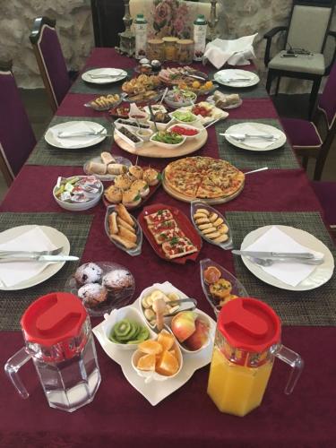 a table full of food on a purple table at Palazzo Banicevic Luxury Rooms in Kotor