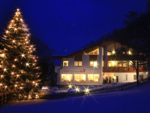 a christmas tree in front of a building at night at Residence Remi in Senales