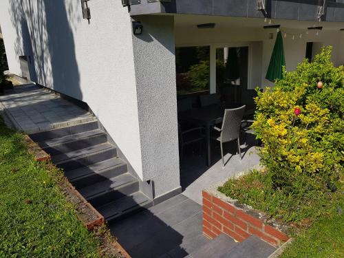 a stairway leading to a house with a table and flowers at Apartment Dolce Vita in Celje