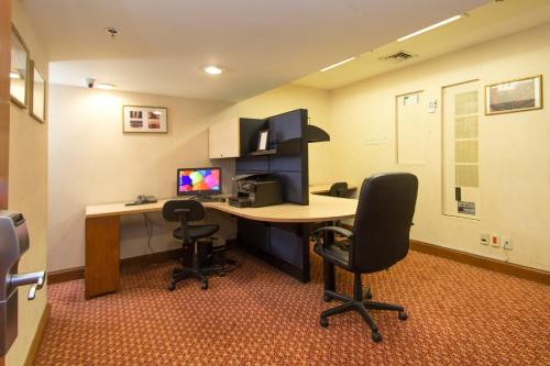 an office with a desk with a computer and two chairs at Gran Hotel Ciudad de México Zócalo View in Mexico City