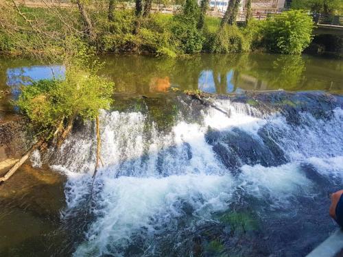 an aerial view of a waterfall in a river at Sleeping Sarria in Sarria