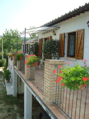 a house with potted plants on a balcony at Poggio San Giacomo in Baschi