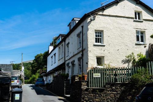 a white building on the side of a street at Treacle Cottage in Ambleside