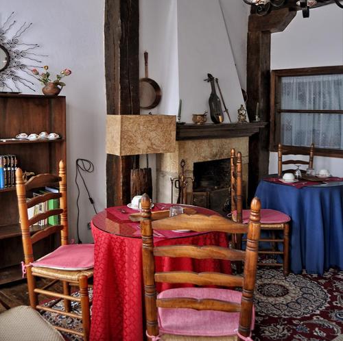 a dining room with a table and a fireplace at Posada Ansorena in Santillana del Mar