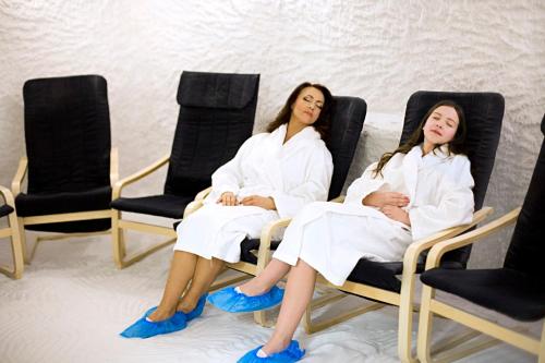 two women in white robes sitting in chairs at Meguva Resort Hotel in Palanga