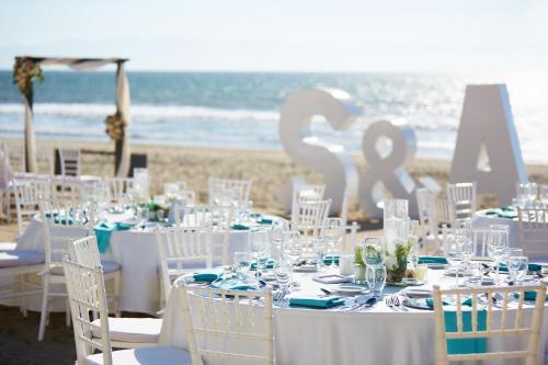 a table set up for a wedding on the beach at Occidental Nuevo Vallarta - All Inclusive in Nuevo Vallarta 