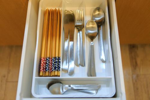 a drawer filled with silver utensils and spoons at ORIGAMI STAY -Taishocho- in Nagoya