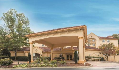 a large building with a pavilion in front of it at La Quinta by Wyndham Raleigh/Durham Southpoint in Durham