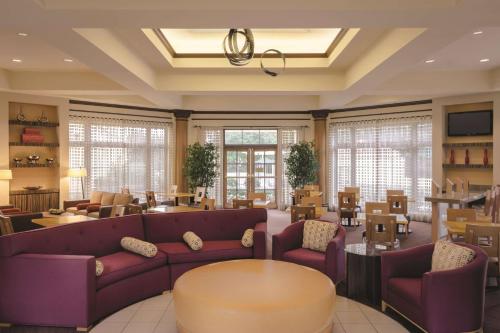 a living room with purple couches and a table and chairs at La Quinta by Wyndham Atlanta Ballpark/Galleria in Atlanta