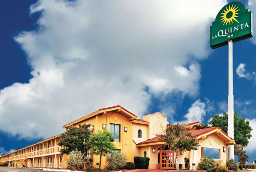 a building with a sign in front of a hotel at La Quinta Inn by Wyndham Odessa in Odessa