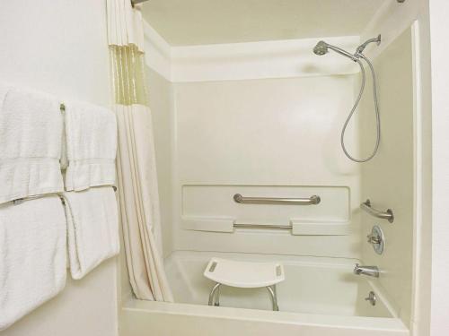a shower in a bathroom with white towels at La Quinta by Wyndham Woodburn in Woodburn