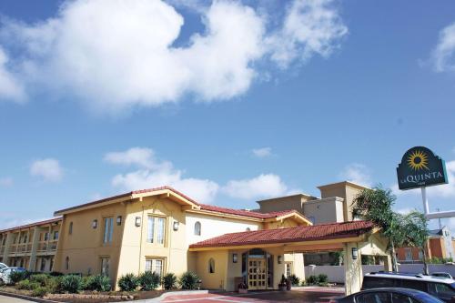 a hotel building with a sign in front of it at La Quinta Inn by Wyndham Clute Lake Jackson in Clute