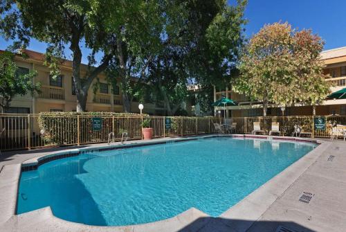 a large swimming pool in front of a building at La Quinta Inn by Wyndham Austin Oltorf in Austin