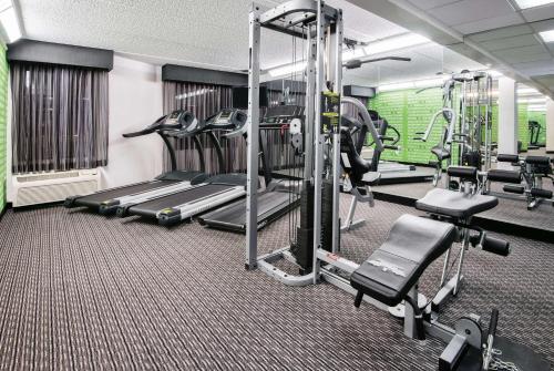 a gym with treadmills and machines in a room at La Quinta Inn & Suites by Wyndham San Antonio Riverwalk in San Antonio