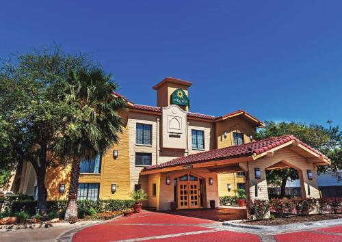 a building with a clock tower on top of it at Travelodge by Wyndham Houston Cy-Fair in Houston