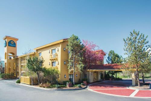 a hotel with a clock tower and a parking lot at La Quinta Inn by Wyndham Denver Westminster in Westminster