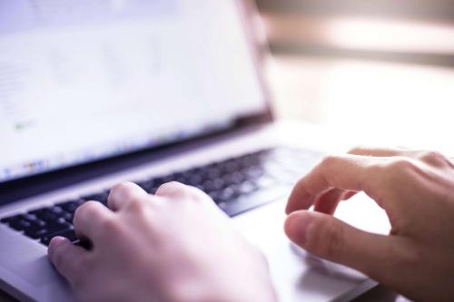 a person is typing on a laptop computer at La Quinta Inn by Wyndham Cheyenne in Cheyenne
