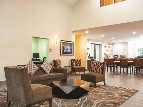 a lobby with a couch and chairs and a table at La Quinta Inn by Wyndham Vancouver Airport in Richmond