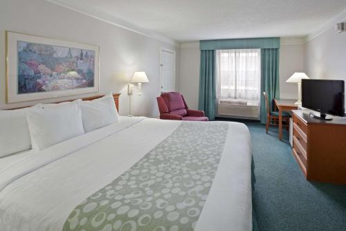 um quarto de hotel com uma cama grande e uma televisão em La Quinta Inn by Wyndham Omaha West em Omaha