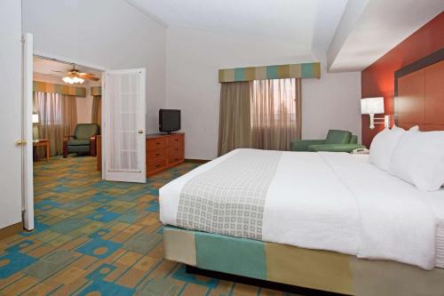 a hotel room with a bed and a television at La Quinta Inn by Wyndham Cheyenne in Cheyenne