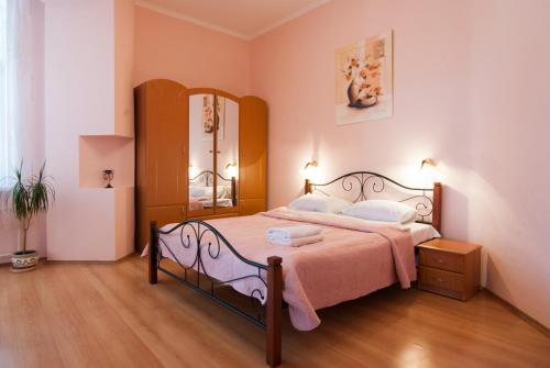 a bedroom with a bed and a mirror in it at Home Hotel Apartments on Mykhailivska Square - Kiev in Kyiv