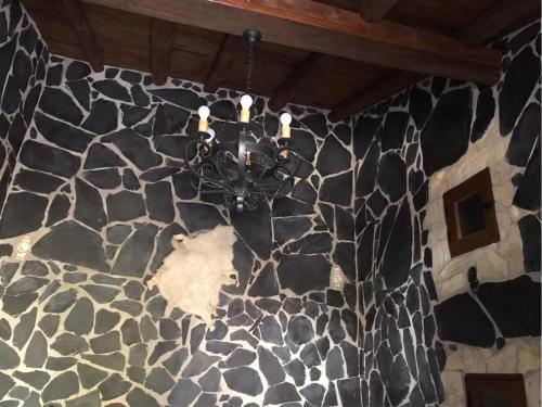 a chandelier hanging from a stone wall at Casa Princess Arminda in Betancuría