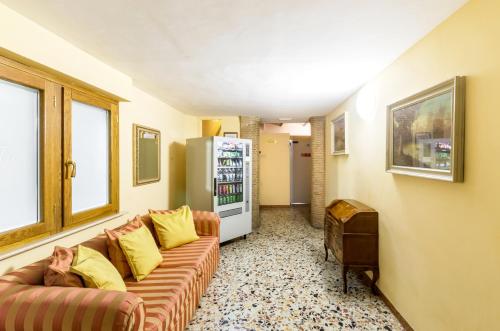 a living room with a couch and a refrigerator at Hotel Tempio Di Pallade in Rome