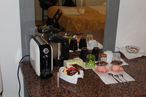 a counter top with a coffee maker and food on it at enrica barrani room in Vernazza