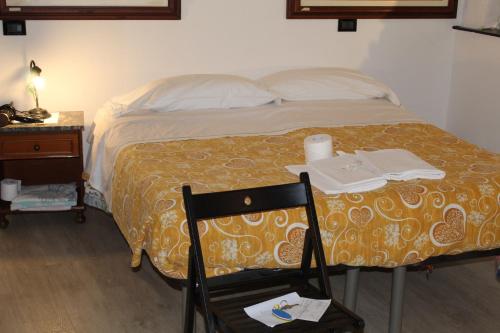 a bedroom with a bed with a chair and a desk at enrica barrani room in Vernazza