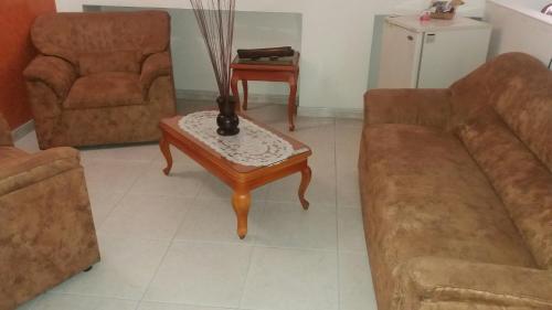 a living room with a couch and a coffee table at HOTEL COSTA DEL SOL FUSAGASUGa in Fusagasuga