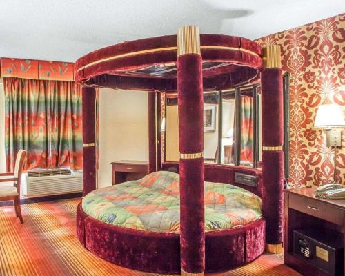 a bedroom with a canopy bed in a room at Days Inn by Wyndham Jersey City in Jersey City