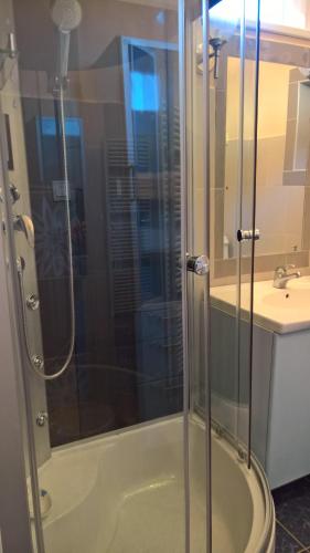 a shower with a glass door in a bathroom at 264 lépés Vendégház in Sárvár