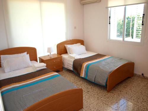 1 dormitorio con 2 camas y ventana en Mariandy 1 en Coral Bay