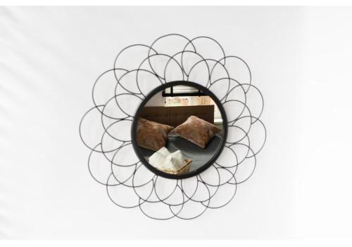 a mirror with a circular design on a white wall at Gostynin Garden Apartment in Gostynin
