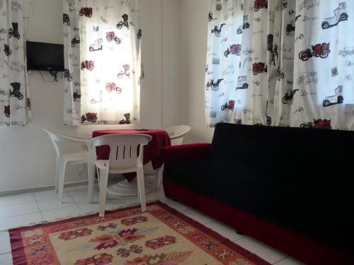 a living room with a couch and a table at Yakut Apart Hotel in Dalyan