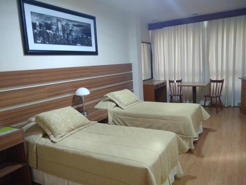 Postel nebo postele na pokoji v ubytování Radio Hotel Resort & Convention