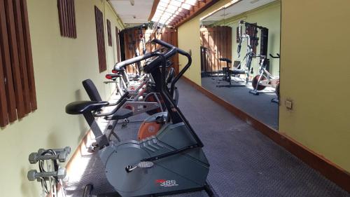 a row of exercise bikes in a gym at Christar Villas Hotel in Kingston