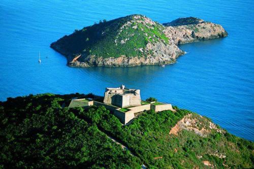 an island in the ocean with a building on it at PENSIONE VERDE LUNA in Orbetello