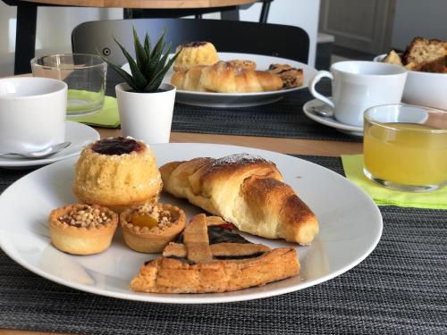 a plate of pastries and bread on a table at Terra di Sicilia Luxury Centro in Avola