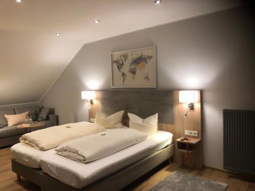 a bedroom with a large bed and a couch at Hotel Senator in Bielefeld