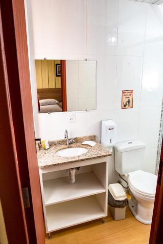 a bathroom with a sink and a toilet at Pousada Solar da Lapa in Lapa