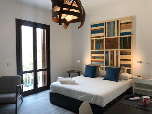 a bedroom with a large bed and a large window at Terra di Sicilia Luxury Centro in Avola