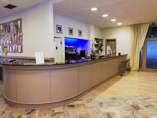a bar in a hotel lobby with a counter at Hotel Touring in Falconara Marittima