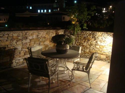 a table and chairs with a vase on a patio at Hotel Pousada Casa Grande in Ouro Preto