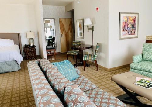 a hotel room with a couch and a bedroom at Wingate by Wyndham Elkins in Elkins