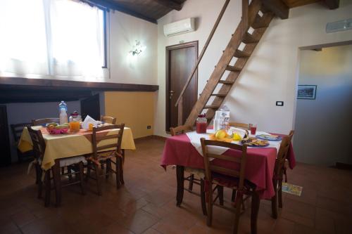 uma sala de jantar com uma mesa e cadeiras e uma escadaria em B&B Salotto Di Athena em Agrigento