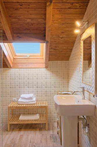 a bathroom with a sink and a mirror at APARTAMENTOS LA LLONGAR in Infiesto