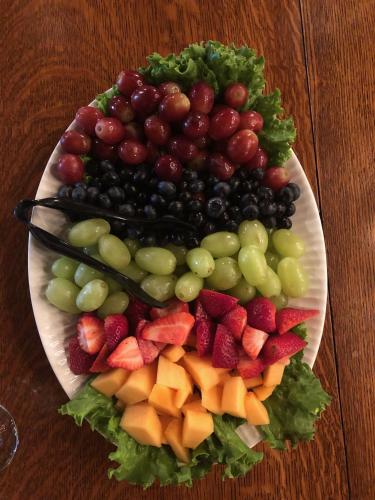 a plate of fruit on a wooden table at The Hancock House Bed & Breakfast Inn in Dubuque