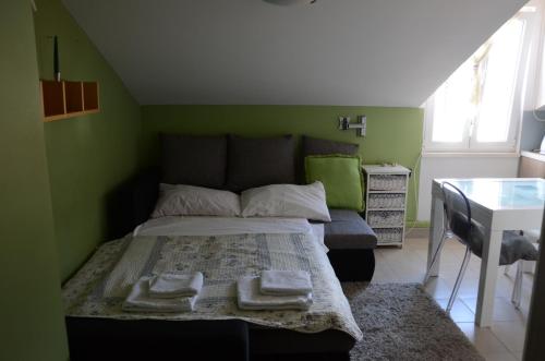 a bedroom with a bed with two towels on it at Apartment Tanja in Cres